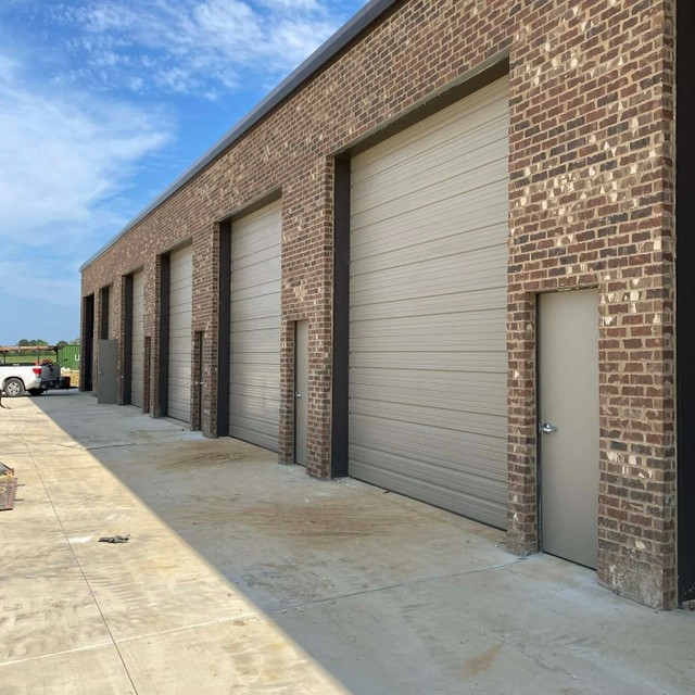 Commercial roll-up doors on brick building