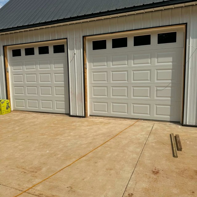 Double white garage doors on metal building